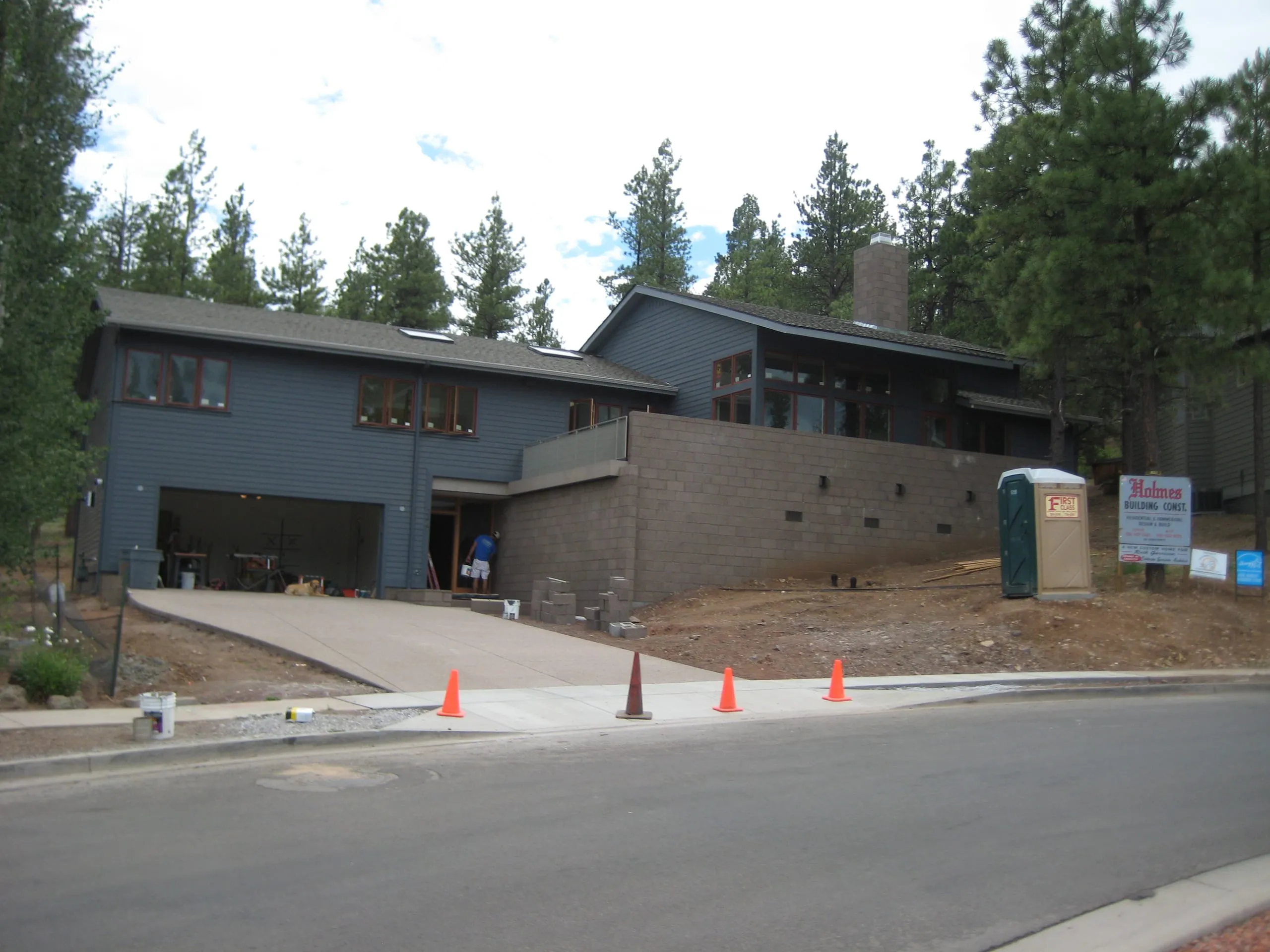 Gray two-story home with an attached garage beside a street